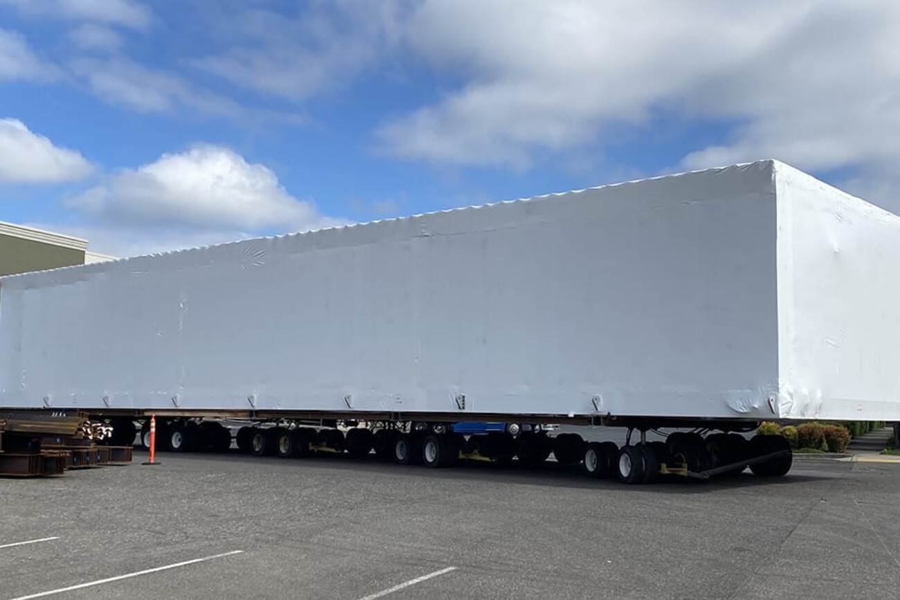 PCC section being transported to barge from factory with automated autonomous towing vehicle