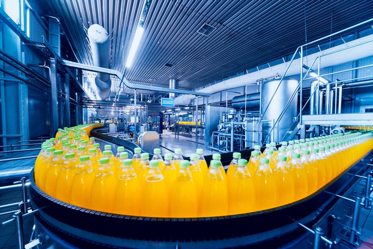 Beverage factory interior. Conveyor with bottles for juice or water. Modern equipments
