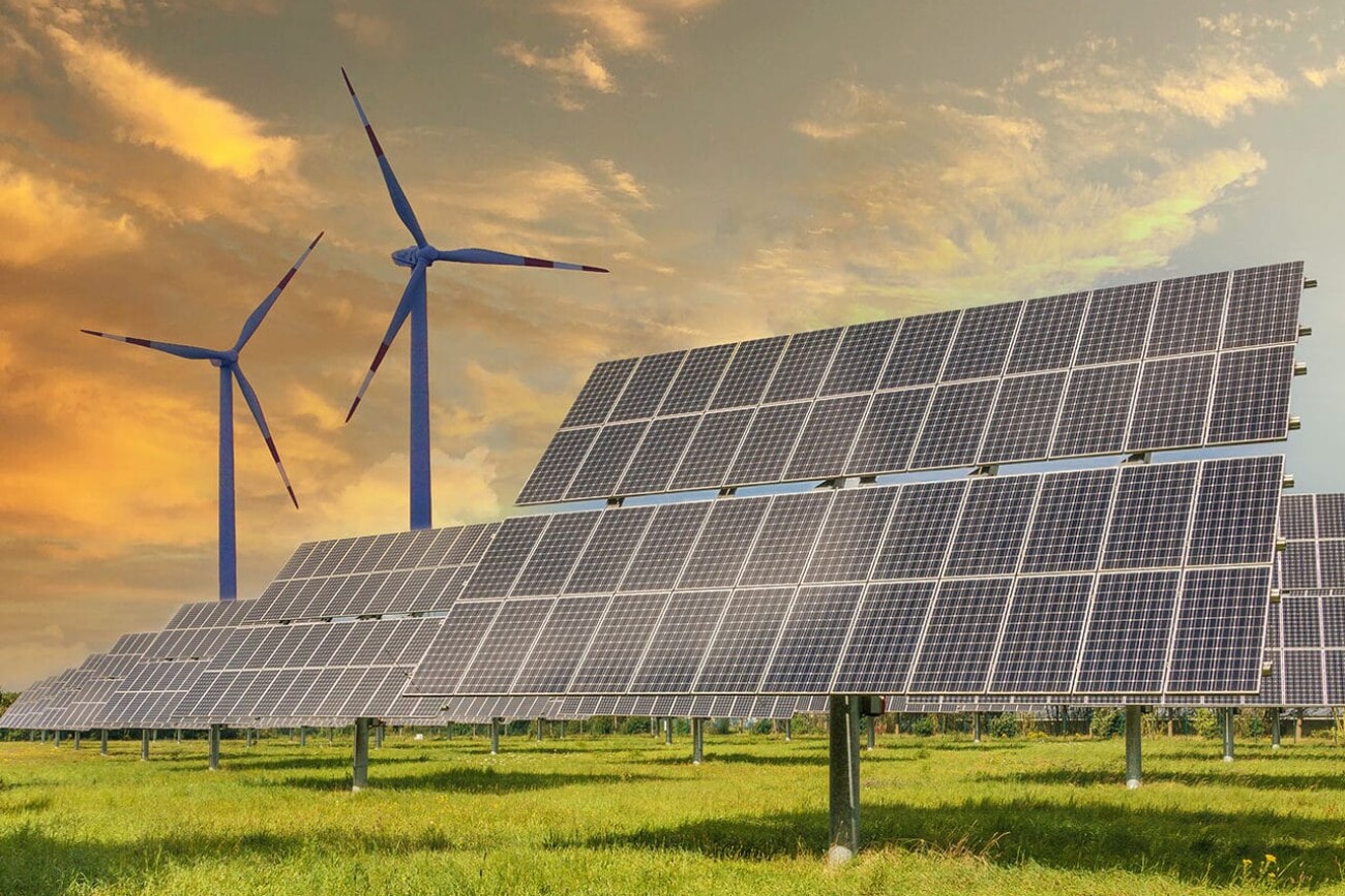Solar panels wind turbines installed as renewable energy sources for electricity and power supply. Innovation and technology, environmental friendly energy. Solar farm under sunny day